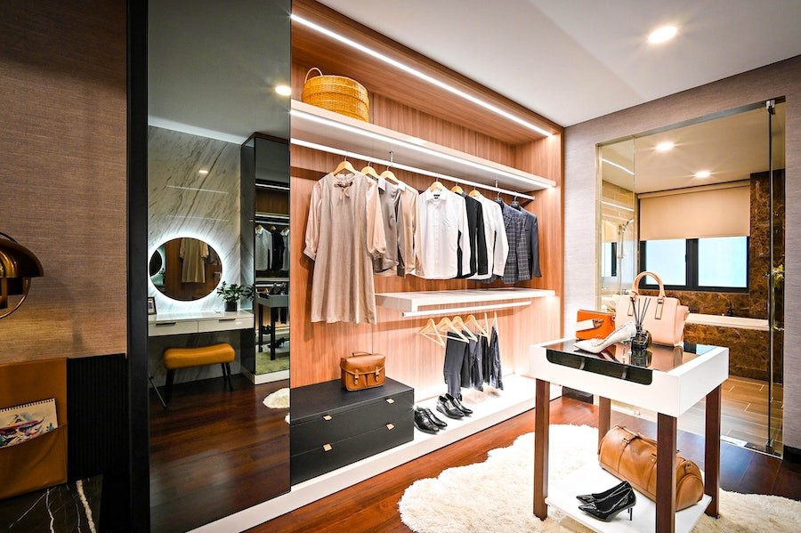 Walk-in closet illuminated by eye-catching lighting design. 