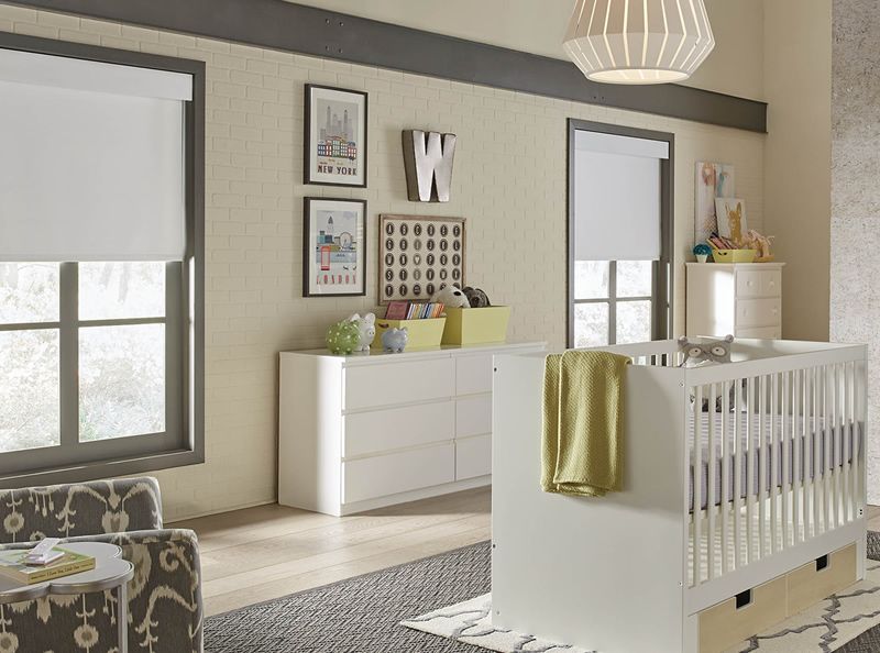 Baby room in neutral colors with halfway closed shades